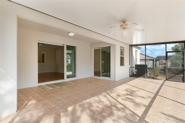 view of patio featuring a lanai and ceiling fan