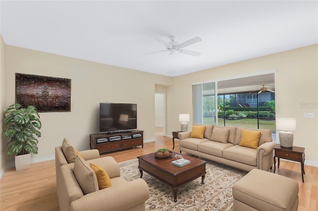 living room featuring ceiling fan and light hardwood / wood-style flooring