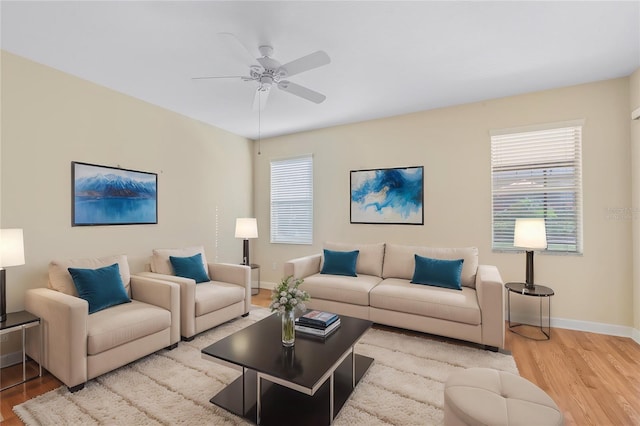 living room with ceiling fan, a healthy amount of sunlight, and light hardwood / wood-style floors