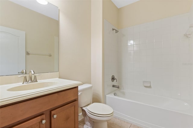 full bathroom featuring vanity, tiled shower / bath, tile patterned floors, and toilet