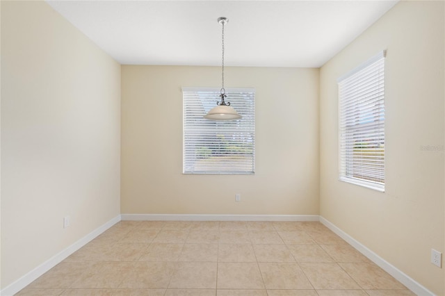 tiled empty room featuring plenty of natural light