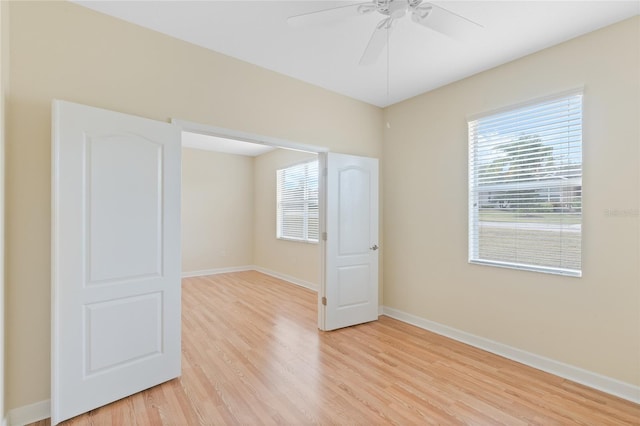 unfurnished room featuring light hardwood / wood-style flooring, plenty of natural light, and ceiling fan