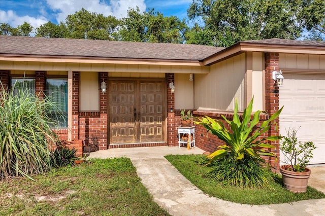 view of exterior entry with a garage