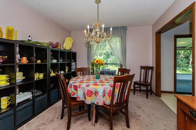 carpeted dining area featuring a chandelier and a textured ceiling