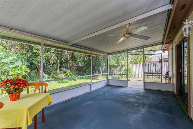 unfurnished sunroom with a wealth of natural light, ceiling fan, and lofted ceiling