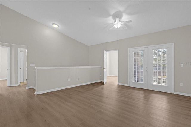 unfurnished room featuring french doors, baseboards, and wood finished floors