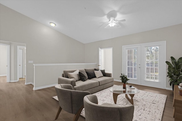 living room with french doors, vaulted ceiling, baseboards, and wood finished floors