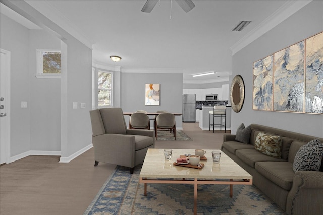 living room featuring hardwood / wood-style floors, ceiling fan, and ornamental molding