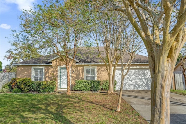 ranch-style home featuring a garage and a front lawn