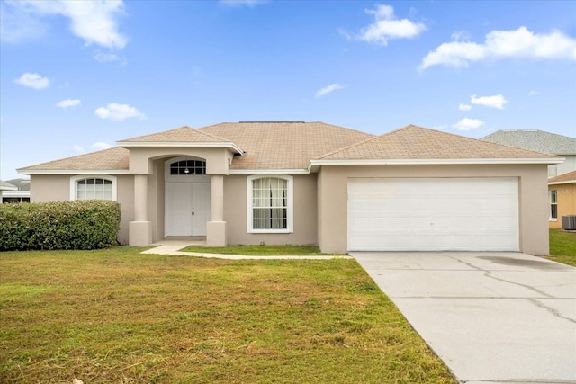 view of front facade featuring central AC, a front lawn, and a garage