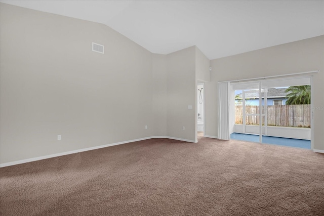 carpeted empty room featuring lofted ceiling