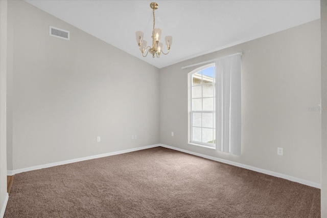 unfurnished room featuring carpet flooring, a notable chandelier, and vaulted ceiling