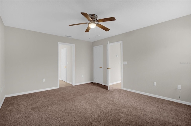 unfurnished bedroom with ceiling fan and light colored carpet