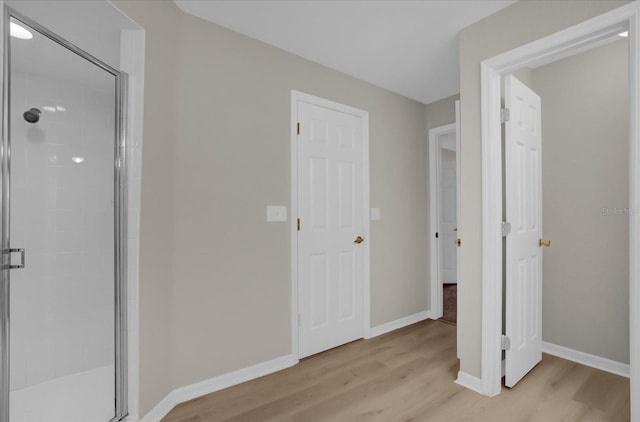 corridor with light wood-type flooring