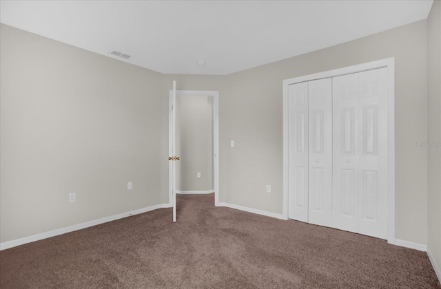 unfurnished bedroom with a closet and carpet