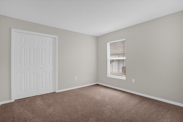 unfurnished bedroom with carpet flooring and a closet