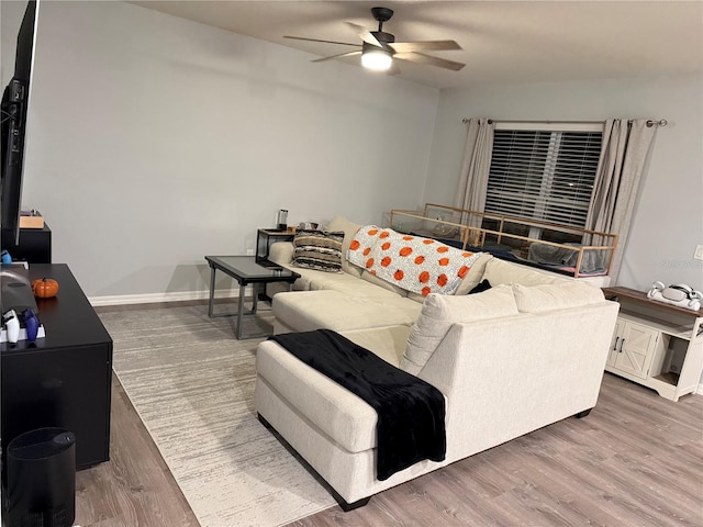 living room with ceiling fan and dark hardwood / wood-style floors