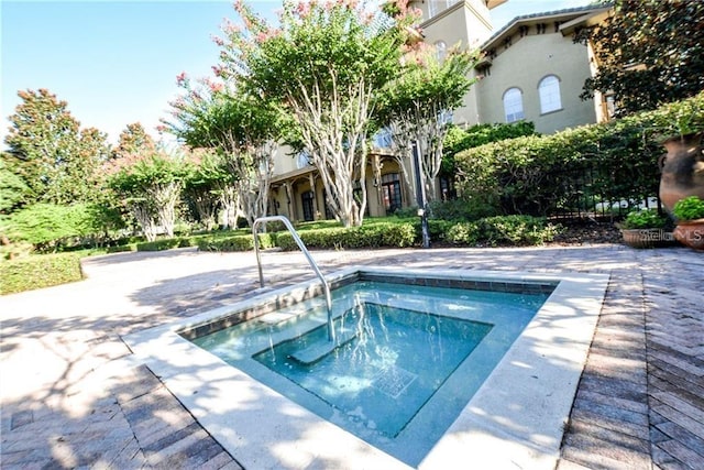 view of swimming pool with an in ground hot tub