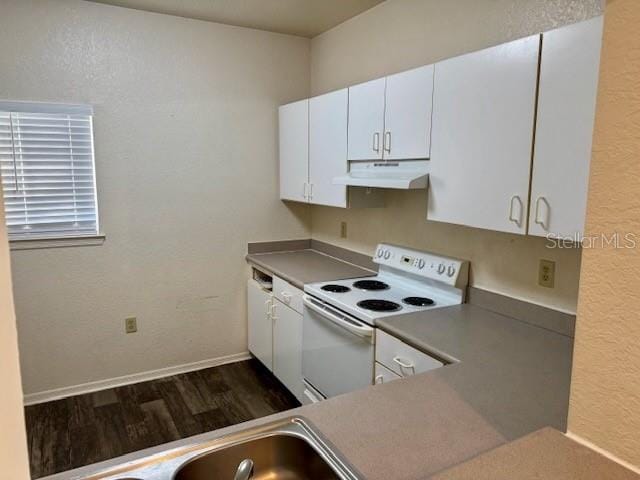 kitchen featuring white electric range oven, white cabinets, dark hardwood / wood-style floors, and sink