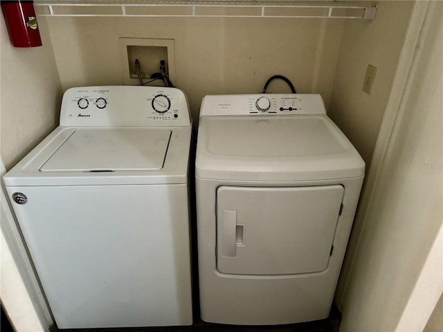 clothes washing area with washing machine and clothes dryer