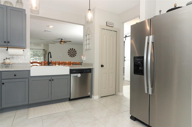 kitchen with gray cabinets, ceiling fan, sink, and stainless steel appliances