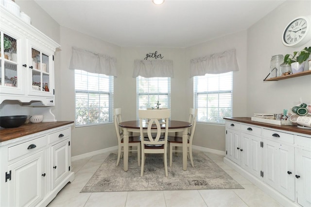 dining area with light tile patterned flooring and a healthy amount of sunlight