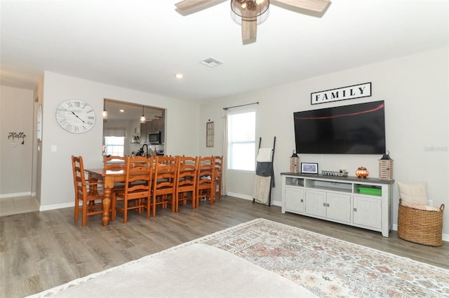 dining room featuring hardwood / wood-style floors and ceiling fan