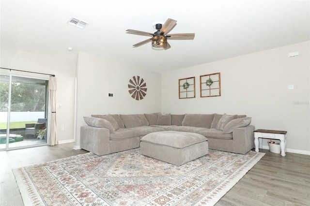 living room with hardwood / wood-style floors and ceiling fan