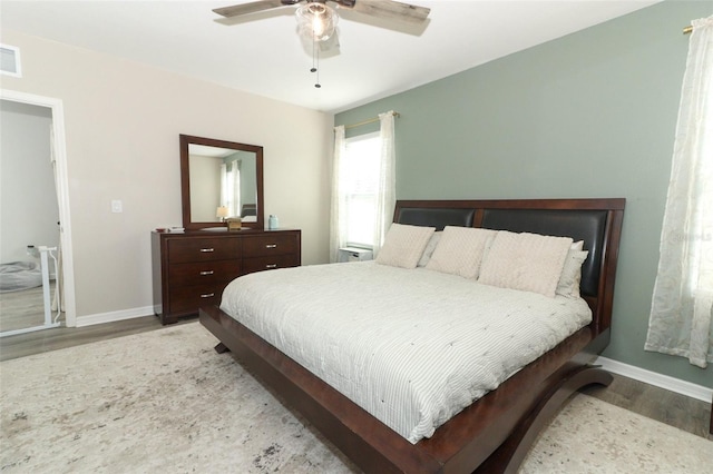 bedroom with ceiling fan and light hardwood / wood-style flooring