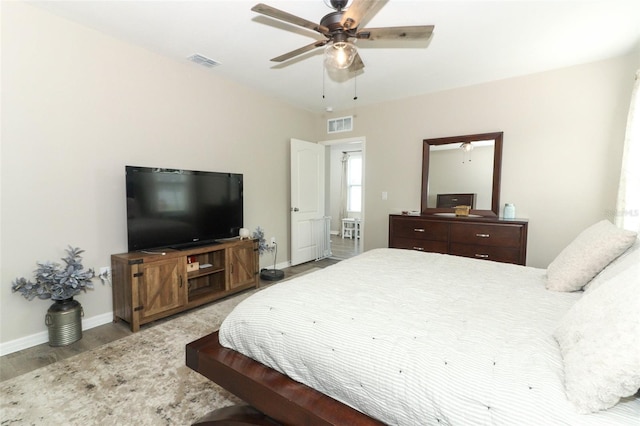 bedroom featuring ceiling fan and hardwood / wood-style flooring