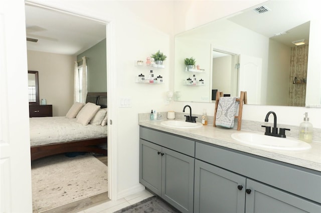 bathroom with hardwood / wood-style flooring, vanity, and ceiling fan