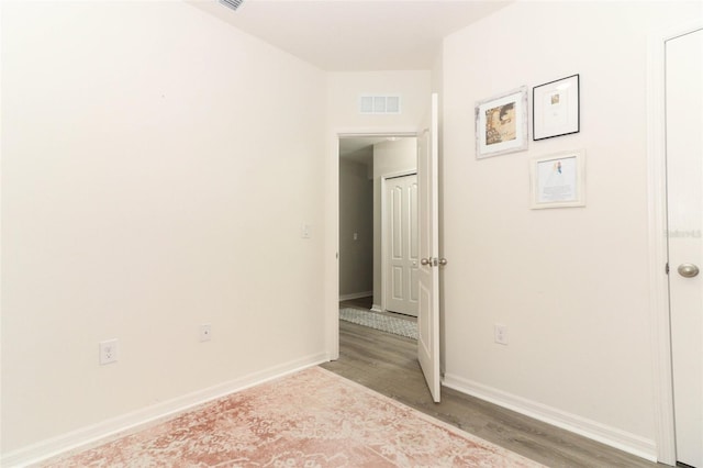 spare room featuring wood-type flooring