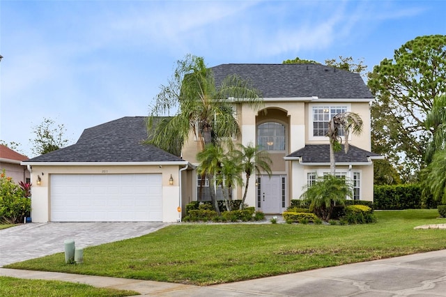 view of front of property featuring a front yard and a garage