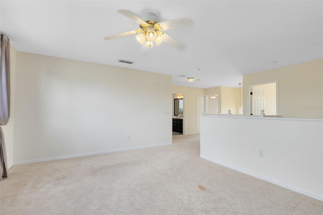 empty room with light colored carpet and ceiling fan