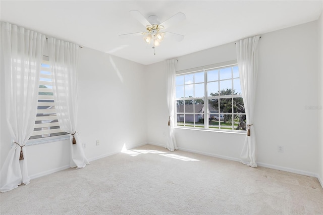 carpeted empty room featuring ceiling fan