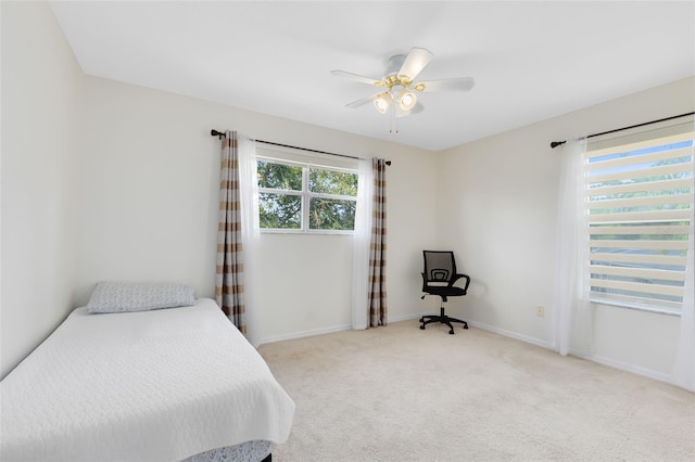 carpeted bedroom featuring ceiling fan