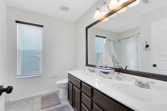 bathroom featuring tile patterned floors, vanity, curtained shower, and toilet