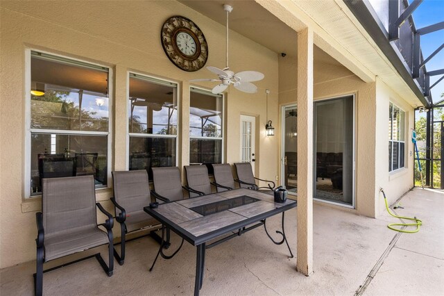 view of patio with ceiling fan and a lanai