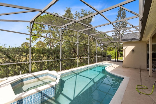 view of pool featuring an in ground hot tub, a patio, and a lanai