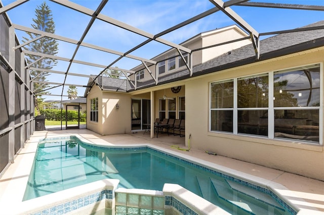 view of pool featuring glass enclosure and a patio