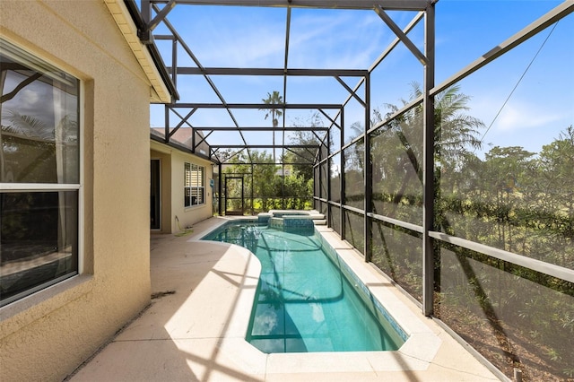 view of pool with a patio area and glass enclosure