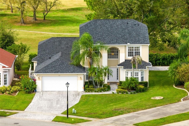 view of front of home featuring a garage and a front lawn