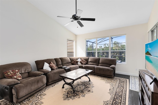 living room featuring dark hardwood / wood-style floors, vaulted ceiling, and ceiling fan