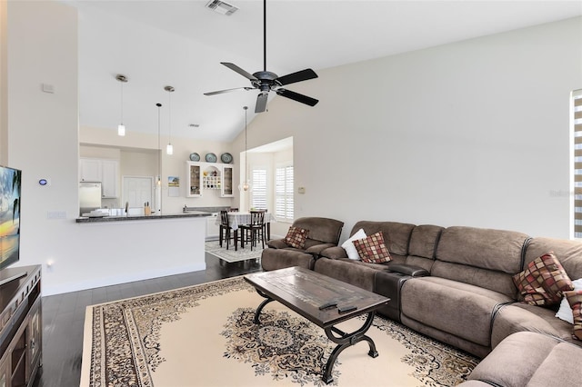 living room featuring ceiling fan, dark wood-type flooring, and high vaulted ceiling