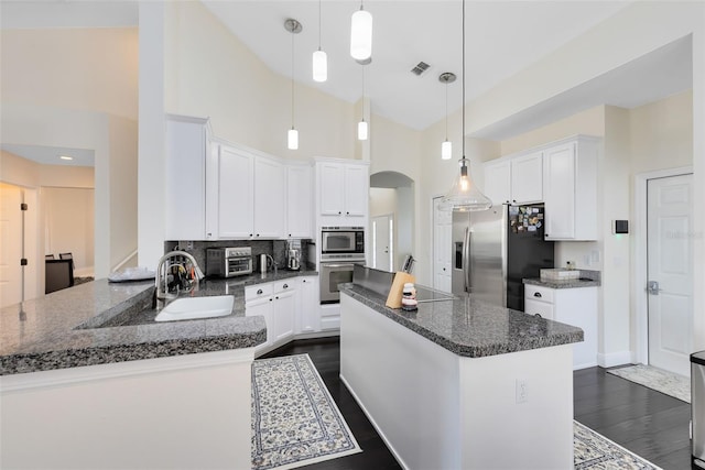 kitchen featuring white cabinetry, high vaulted ceiling, and appliances with stainless steel finishes