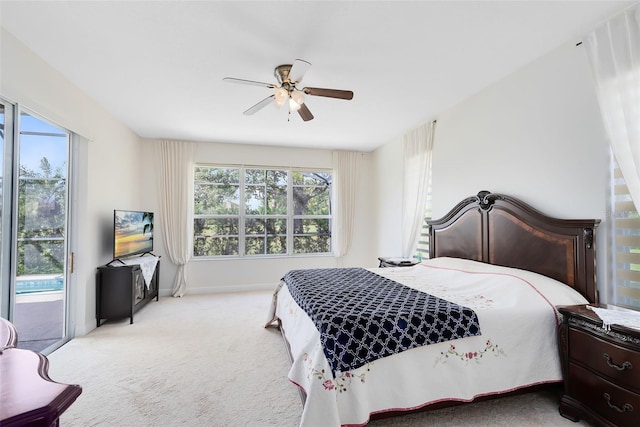 bedroom with access to exterior, light colored carpet, and ceiling fan