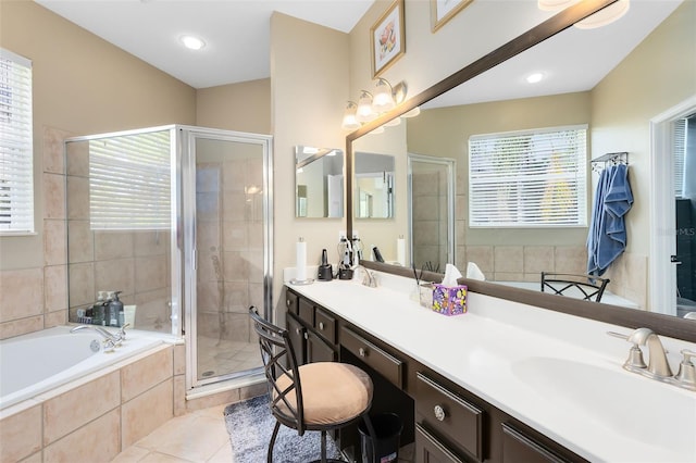 bathroom featuring tile patterned flooring, vanity, and shower with separate bathtub