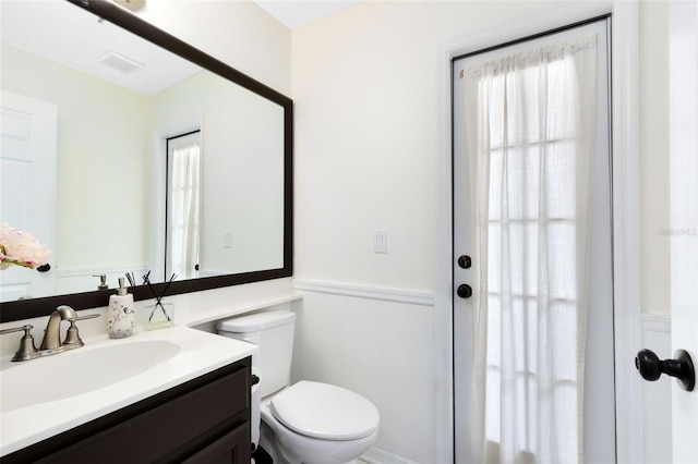 bathroom featuring vanity and toilet