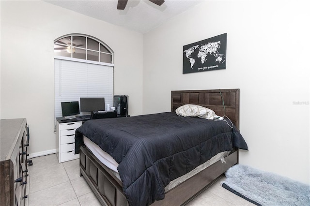 tiled bedroom with ceiling fan and a textured ceiling