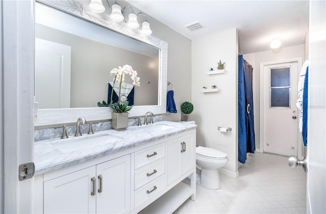 bathroom with tile patterned floors, vanity, and toilet